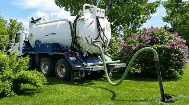 Professional vacuum truck performing residential drainage and septic maintenance in Bradenton, FL