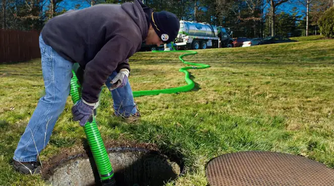 Service technician performing residential septic pumping and drainage maintenance in Bradenton, FL